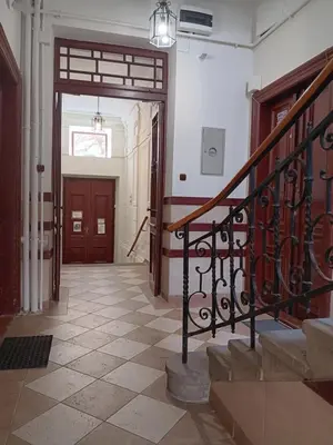 a hallway of a building with a staircase and a door at Apartament Niebieski in Kraków