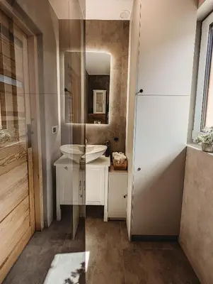 a bathroom with a sink and a mirror at Beskidzka Kraina in Porąbka