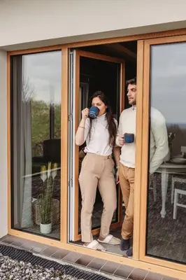 a man and a woman standing in a doorway drinking coffee at Beskidzka Kraina in Porąbka
