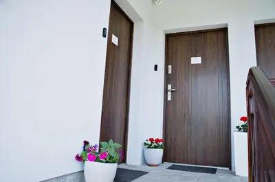 two doors with potted plants in front of them at Apartamenty na Zatorskiej by Housine in Zator