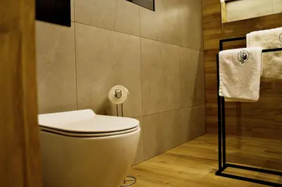 a bathroom with a toilet and a roll of toilet paper at Apartamenty na Zatorskiej by Housine in Zator