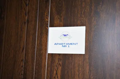 a sign on a wooden door with a sign on it at Apartamenty na Zatorskiej by Housine in Zator