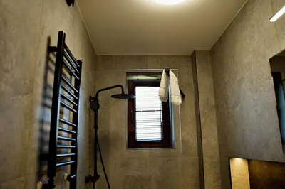 a bathroom with a shower and a window at Apartamenty na Zatorskiej by Housine in Zator