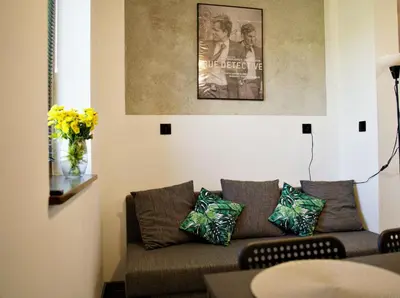 a living room with a couch and a picture on the wall at Apartamenty na Zatorskiej by Housine in Zator