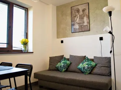 a living room with a couch and a table at Apartamenty na Zatorskiej by Housine in Zator