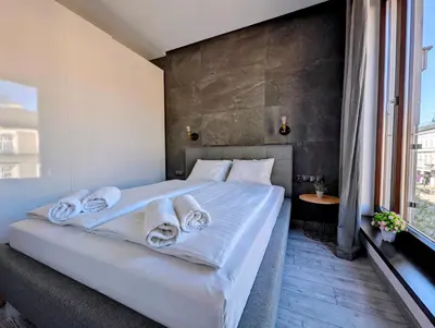 a bedroom with a white bed with towels on it at Kościuszki 28 B by Homeprime in Kraków