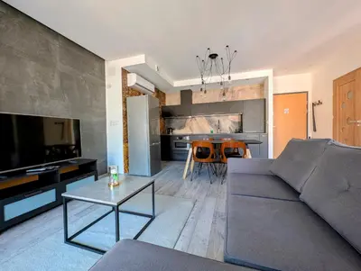 a living room with a couch and a table at Kościuszki 28 B by Homeprime in Kraków