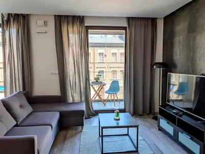 a living room with a couch and a tv at Kościuszki 28 B by Homeprime in Kraków
