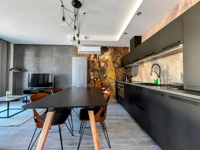 a kitchen with a black table and some chairs at Kościuszki 28 B by Homeprime in Kraków