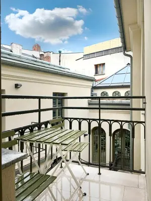 a balcony with a wooden bench on a building at Studio Premium with Air Conditioning for couples in the heart of Krakow, Main Square in Kraków
