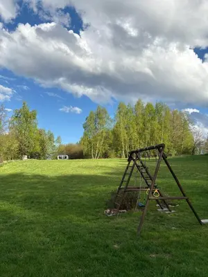 a swing set in the middle of a field at Wiejska Przystań blisko Energylandii in Po”łwieś