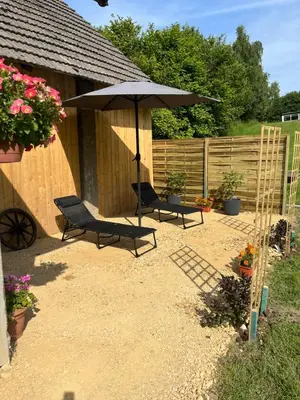 a patio with two chairs and an umbrella at Wiejska Przystań blisko Energylandii in Po”łwieś