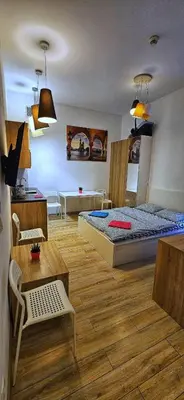 a bedroom with two beds and a table and chairs at M Apartment Bosacka 7 in Kraków
