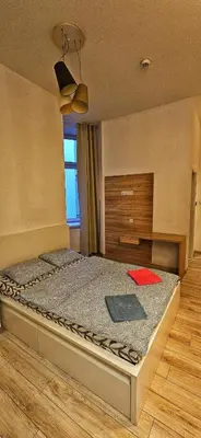 a bedroom with a bed with a red object on it at M Apartment Bosacka 7 in Kraków