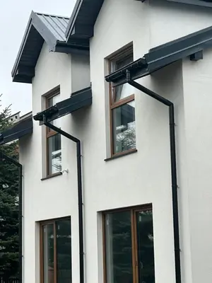 a white house with black windows on it at Lawendlove in Kraków