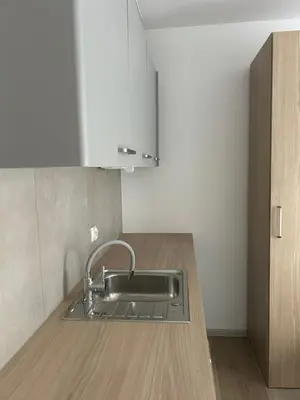 a kitchen with a sink and a wooden counter at Lawendlove in Kraków