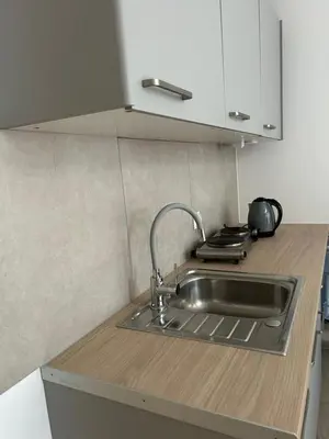 a kitchen with a sink and a counter top at Lawendlove in Kraków