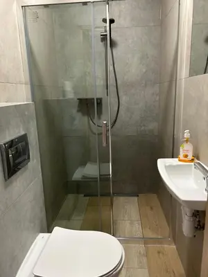 a bathroom with a shower and a toilet and a sink at Lawendlove in Kraków