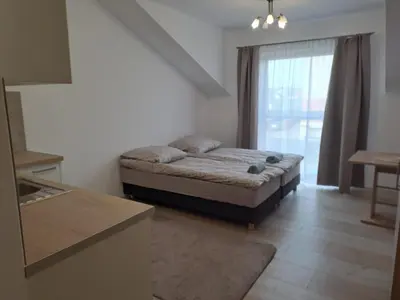 a small bedroom with a bed and a window at Lawendlove in Kraków