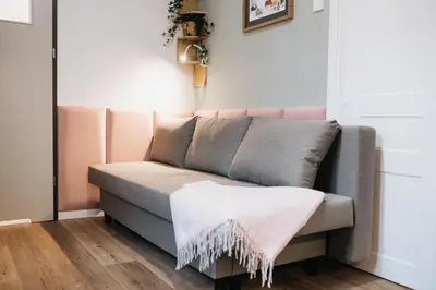 a couch with a blanket on it in a room at Celna Corner in Kraków