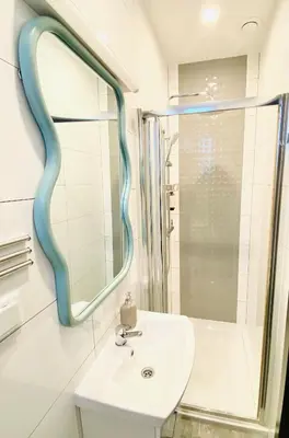 a bathroom with a sink and a mirror at Celna Corner in Kraków