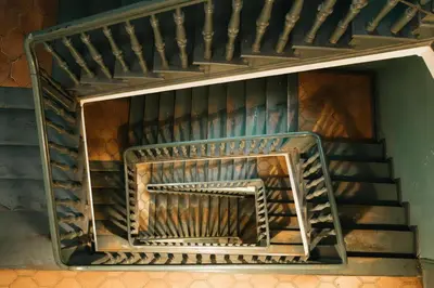 a staircase in a building with a fire place at Celna Corner in Kraków