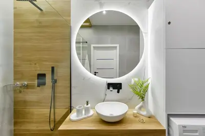 a bathroom with a sink and a mirror at Cosy Blue Cracow Apartment in Kraków