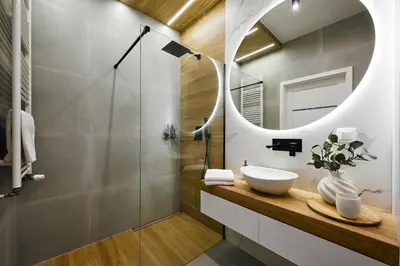 a bathroom with a sink and a mirror at Cosy Blue Cracow Apartment in Kraków