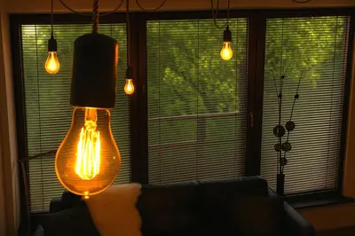 a living room with a couch and a lamp at Kopernik-us 2 rooms - Old Town in Kraków
