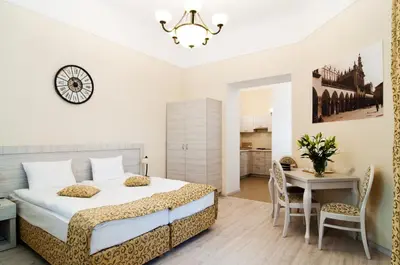 a bedroom with a bed and a table and chairs at Apartamenty Bonerowska 5 in Kraków