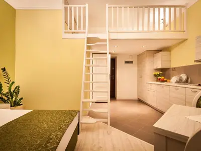 a room with a loft bed in a kitchen at Apartamenty Bonerowska 5 in Kraków
