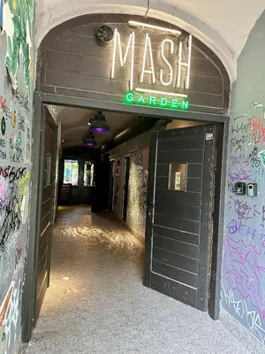 a hallway with a mash carillon sign over a door at Wolnica Apartament 1 in Kraków