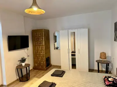 a living room with a television and a room with a tvictericter at Wolnica Apartament 1 in Kraków