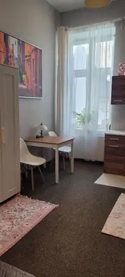 a living room with a table and a window at Cozy Apartment 4A in Kraków