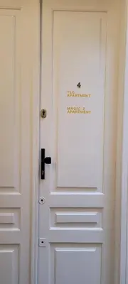 a white door with a sign on it at Cozy Apartment 4A in Kraków
