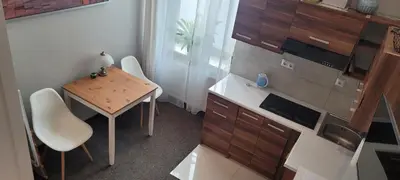 a small kitchen with a table and a small table and chairs at Cozy Apartment 4A in Kraków
