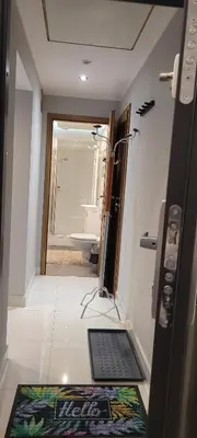 a bathroom with a mirror and a sink and a toilet at Cozy Apartment 4A in Kraków