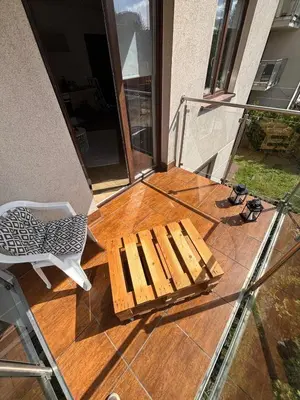 a wooden bench sitting on top of a porch at Cozy Studio Apartment Krakow in Kraków