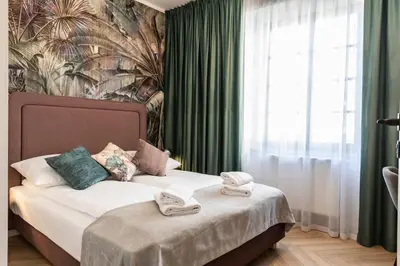a bedroom with a bed with two towels on it at Dom Pod Kotwicą in Kraków