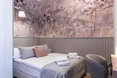 a bedroom with a bed with a painting on the wall at Dom Pod Kotwicą in Kraków