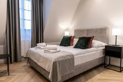 a bedroom with a large bed with towels on it at Dom Pod Kotwicą in Kraków