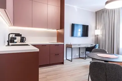 a kitchen and dining room with a table and chairs at Dom Pod Kotwicą in Kraków