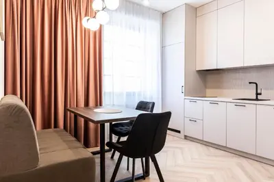a kitchen with a table and chairs in a room at Dom Pod Kotwicą in Kraków