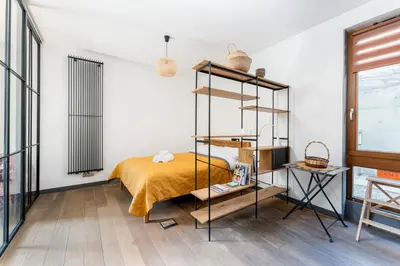 a bedroom with a bed and a book shelf at Jesionowa Homely Apartment with Garden by BookingHost in Kraków