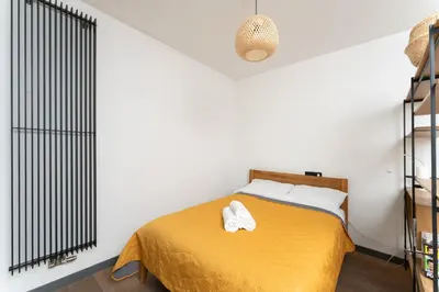 a bedroom with a bed with two towels on it at Jesionowa Homely Apartment with Garden by BookingHost in Kraków
