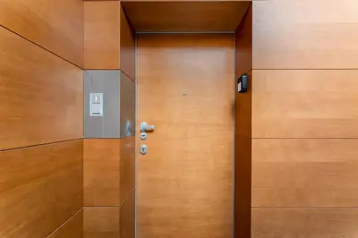 a wooden elevator with a door in a building at Jesionowa Homely Apartment with Garden by BookingHost in Kraków