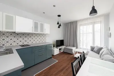 a kitchen and living room with a couch and a table at Kościuszki apartment with parking by Nearto pl in Kraków