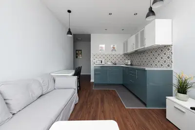 a living room with a couch and a kitchen at Kościuszki apartment with parking by Nearto pl in Kraków
