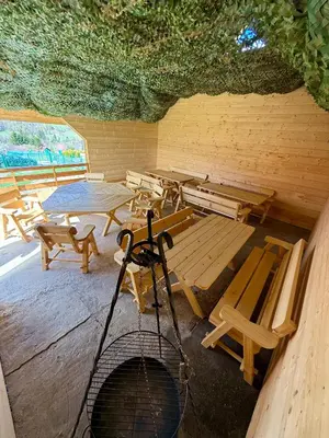 a group of picnic tables and benches in a room at Pod Lachowym Groniem in Koszarawa