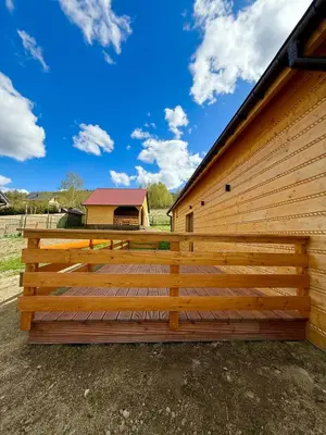 a wooden fence next to a building at Pod Lachowym Groniem in Koszarawa